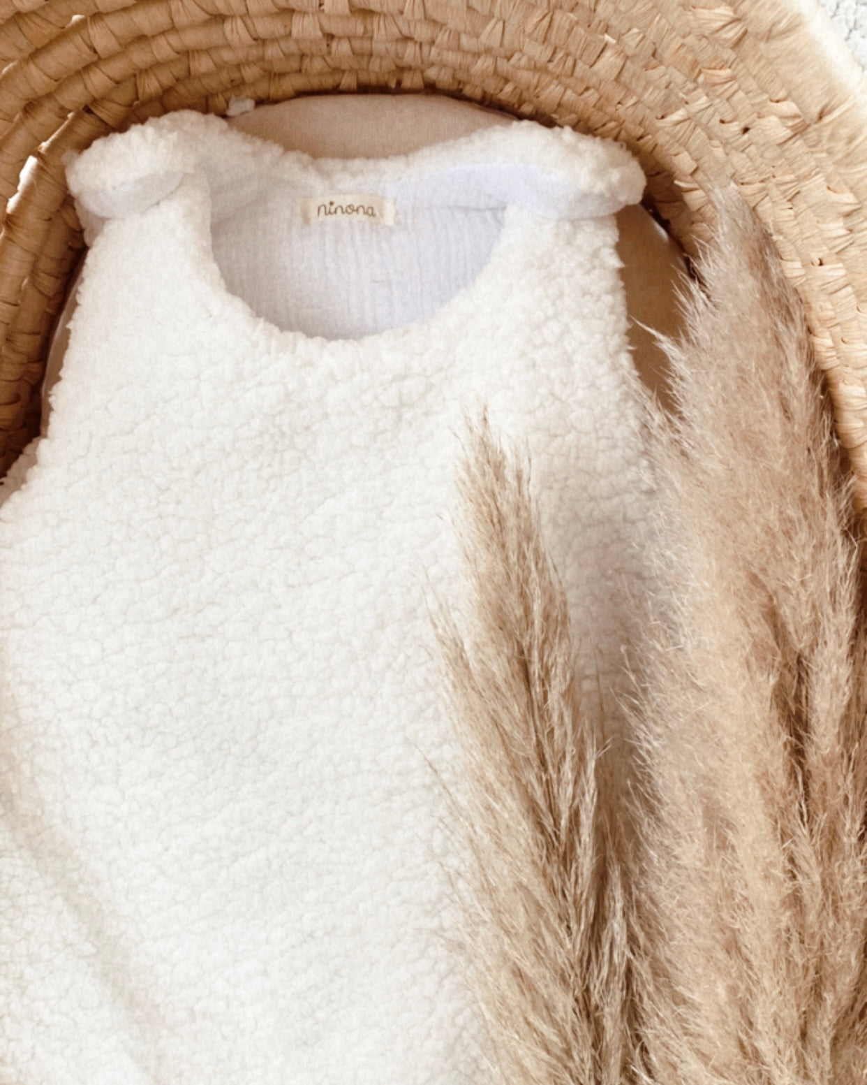 Gigoteuse artisanale Ninona en sherpa chaud et coton double gaze, confectionnée à la main en France. Disponible en blanc et beige, elle est pensée pour offrir confort, chaleur et sécurité au sommeil de bébé. Un indispensable pour les futures mamans et papas qui recherchent un article fait main, unique et cocooning pour la chambre de leur bébé d’hiver. Idée cadeau de naissance idéale.